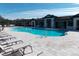Resort-style pool with lounge chairs and shaded seating areas at 11992 Blazing Star Dr, Venice, FL 34293