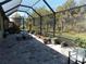 Spacious screened patio with pavers and plants at 11992 Blazing Star Dr, Venice, FL 34293