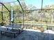 Enjoy this screened patio with seating and tranquil nature views at 11992 Blazing Star Dr, Venice, FL 34293