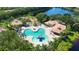 Community pool, playground, and clubhouse with lake view at 12338 Lavender Loop, Bradenton, FL 34212