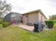 Landscaped backyard with covered patio, grill, and pool at 12338 Lavender Loop, Bradenton, FL 34212