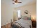 Bedroom with a queen bed, wood floors, and ceiling fan at 12338 Lavender Loop, Bradenton, FL 34212