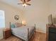 Bedroom with a queen bed, wood floors, and ceiling fan at 12338 Lavender Loop, Bradenton, FL 34212