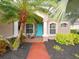 Welcoming front entrance with teal door and palm trees at 12338 Lavender Loop, Bradenton, FL 34212