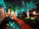 Attractive front yard with palm trees and landscape lighting at night at 12338 Lavender Loop, Bradenton, FL 34212