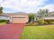 House exterior with two-car garage and landscaping at 12338 Lavender Loop, Bradenton, FL 34212