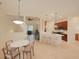 Open kitchen with white island, breakfast bar, and dining area at 12338 Lavender Loop, Bradenton, FL 34212