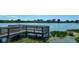 Serene lakefront view with a wooden dock at 12338 Lavender Loop, Bradenton, FL 34212