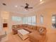 Bright and airy living room features a large sectional sofa and backyard access at 12338 Lavender Loop, Bradenton, FL 34212