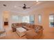 Spacious living room with comfortable sectional sofa and access to the backyard at 12338 Lavender Loop, Bradenton, FL 34212