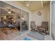 View from the balcony into the living area with gray sofas and comfortable furniture at 1600 1St W Ave # 304A, Bradenton, FL 34205