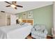 Cozy bedroom with green walls, comfortable chair, and a door to the bathroom at 1600 1St W Ave # 304A, Bradenton, FL 34205