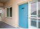 Apt 304 entryway featuring a light blue door with a window showcasing the building's exterior at 1600 1St W Ave # 304A, Bradenton, FL 34205