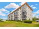 Exterior of the apartment building with lush green lawn and manicured landscaping, under a blue sky at 1600 1St W Ave # 304A, Bradenton, FL 34205