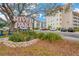 River Oaks condo complex, featuring building exterior, parking, and landscaping at 1600 1St W Ave # 304A, Bradenton, FL 34205