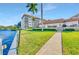 Scenic waterfront view of the building, green lawn, and mature palm trees at 1600 1St W Ave # 304A, Bradenton, FL 34205