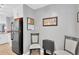 Kitchen eating area features a black fridge, gray walls, and table and chairs at 1600 1St W Ave # 304A, Bradenton, FL 34205