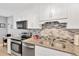 Updated kitchen features granite countertops and stainless steel appliances at 1600 1St W Ave # 304A, Bradenton, FL 34205