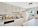 Functional kitchen space featuring white cabinetry, appliances, and a scenic window view at 1600 1St W Ave # 304A, Bradenton, FL 34205