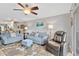 Comfortable living room with a large window, ceiling fan, gray sofas, and stylish floral rug at 1600 1St W Ave # 304A, Bradenton, FL 34205