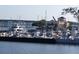 Picturesque marina view featuring an array of boats docked along the waterfront, with a building and bridge in the background at 1600 1St W Ave # 304A, Bradenton, FL 34205
