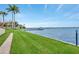 A beautiful waterfront view showing a well maintained lawn and a pier at 1600 1St W Ave # 304A, Bradenton, FL 34205
