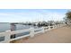 Scenic waterfront sidewalk with white concrete railing overlooking docks and moored boats at 1600 1St W Ave # 304A, Bradenton, FL 34205