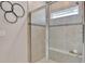 Modern bathroom with a walk-in shower, tiled walls, and a built-in seat at 16257 S Port Harbor Blvd, Port Charlotte, FL 33953