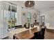 Rustic farmhouse dining room with wooden table and access to backyard at 16257 S Port Harbor Blvd, Port Charlotte, FL 33953