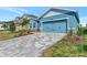 Gray paved driveway leading to a light blue house at 16257 S Port Harbor Blvd, Port Charlotte, FL 33953