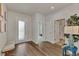 Bright entryway with hardwood floors, bench, and access to bathroom at 16257 S Port Harbor Blvd, Port Charlotte, FL 33953