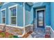 Front door entrance with stone detailing and a welcome sign at 16257 S Port Harbor Blvd, Port Charlotte, FL 33953