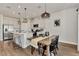 Modern kitchen with white cabinets, farmhouse table, and pendant lighting at 16257 S Port Harbor Blvd, Port Charlotte, FL 33953