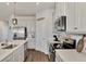 Modern kitchen with white cabinets, stainless steel appliances and an island at 16257 S Port Harbor Blvd, Port Charlotte, FL 33953
