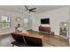 Bright living room with hardwood floors, stylish furniture, and a large TV at 16257 S Port Harbor Blvd, Port Charlotte, FL 33953