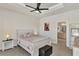 Spacious main bedroom with ceiling fan, large bed, and ensuite bathroom access at 16257 S Port Harbor Blvd, Port Charlotte, FL 33953