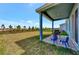 Covered patio with seating area and backyard access at 16257 S Port Harbor Blvd, Port Charlotte, FL 33953