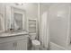 Clean bathroom with a shower/tub combo and a granite vanity at 18212 Cayo Largo Pl, Lakewood Ranch, FL 34202