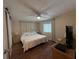 Bright bedroom with a king-size bed and wood-look floors at 2107 Palma Sola Blvd # 42, Bradenton, FL 34209