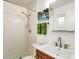 Simple bathroom with shower and white tile at 2135 Hyde Park Cir, Sarasota, FL 34239