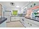 Mid-century modern kitchen with white cabinets and terrazzo floor at 2135 Hyde Park Cir, Sarasota, FL 34239