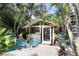 Charming outdoor bar and seating area nestled within tropical foliage at 2135 Hyde Park Cir, Sarasota, FL 34239