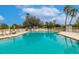 Sparkling community pool surrounded by lush greenery at 2224 Lynx Run, North Port, FL 34288