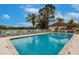 Community pool with plenty of lounge chairs at 2224 Lynx Run, North Port, FL 34288