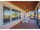 Bright screened porch with white chairs and view of neighborhood at 2412 Crescent E Ct, Bradenton, FL 34208