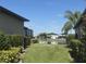 Landscaped backyard with pond and neighboring homes view at 2536 Marton Oak Blvd, North Port, FL 34289