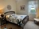 Bedroom with double bed, chair, and neutral decor at 2536 Marton Oak Blvd, North Port, FL 34289
