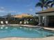 Relax by the community pool with lounge chairs and palm trees at 2536 Marton Oak Blvd, North Port, FL 34289