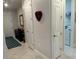 Bright entryway with tile flooring, storage closet, and laundry access at 2536 Marton Oak Blvd, North Port, FL 34289