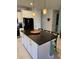 Modern kitchen with island, granite countertops, and stainless steel appliances at 2536 Marton Oak Blvd, North Port, FL 34289